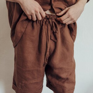 May include: A pair of brown linen shorts with a drawstring waist.