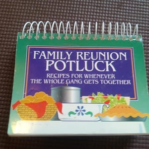 May include: A spiral-bound cookbook titled Family Reunion Potluck: Recipes for Whenever the Whole Gang Gets Together. The cover features a green border and a blue central panel with illustrations of a basket of rolls, a pot, a bowl, and a pie.