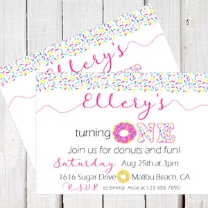 May include: A pink and white donut-themed birthday invitation for a girl turning one. The invitation features a pink donut with colorful sprinkles, the words "Ellery's turning ONE", and the text "Join us for donuts and fun! Saturday Aug 25th at 3pm 1616 Sugar Drive Malibu Beach, CA R.S.V.P to Emma Alice at 123 456 7890".