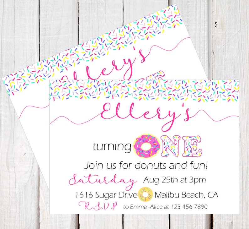 May include: A pink and white donut-themed birthday invitation for a girl turning one. The invitation features a pink donut with colorful sprinkles, the words "Ellery's turning ONE", and the text "Join us for donuts and fun! Saturday Aug 25th at 3pm 1616 Sugar Drive Malibu Beach, CA R.S.V.P to Emma Alice at 123 456 7890".