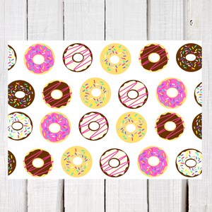 May include: A white background with a repeating pattern of colorful donuts with pink frosting and sprinkles. The donuts are arranged in a grid pattern.