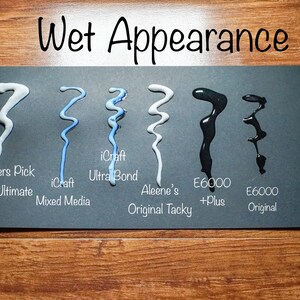 May include: A black card displays samples of various adhesives, showcasing their "Wet Appearance." The samples include Crafters Pick, iCraft, Aleene's, and E6000, each in a unique wavy pattern. The text "Wet Appearance" is at the top.