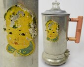 Vintage Pyrex baby bottle warmer with pink handle