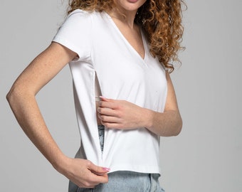 May include: A white v-neck t-shirt with a side slit detail. The shirt is made of a soft, comfortable fabric and has a relaxed fit.