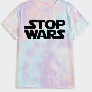 May include: A tie-dye t-shirt with a black print that says "STOP WARS".