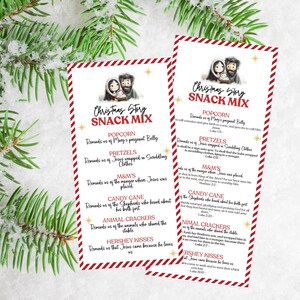 May include: Two printable Christmas Story Snack Mix cards with red and white stripes. The cards feature a cartoon illustration of Mary, Joseph, and baby Jesus. Each card lists different snacks and their corresponding meaning in the Christmas story. The text on the cards reads "Christmas Story Snack Mix".