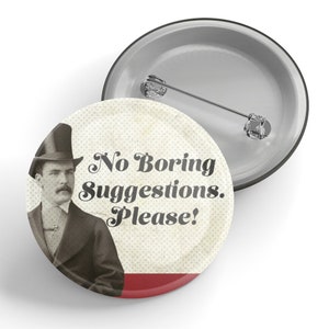 May include: A vintage-style button with a man in a top hat and the text "No Boring Suggestions. Please!" in a retro font. The button is white with a red stripe at the bottom.