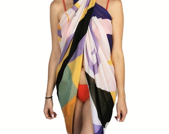 May include: A colorful sarong with a geometric pattern in shades of yellow, green, purple, black, and white. The sarong is wrapped around the body, creating a stylish beach cover-up.
