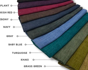May include: A collection of folded fabric swatches in various colors, including black, eggplant, pinkish red, ebony, navy, gray, baby blue, turquoise, khaki, grass green, and rusty green. Each color is labeled with its name in white text.
