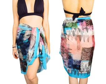 May include: A colorful sarong with a blue, pink, and white pattern. The sarong is tied around the waist and has a fringe on the bottom.