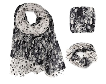 May include: A black and white scarf with a paw print pattern on one side and a pattern of dogs on the other side. The scarf is made of a soft, lightweight fabric.