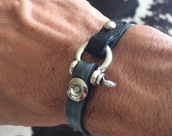 small silver shackle on gunmetal gray leather with silver button clasp