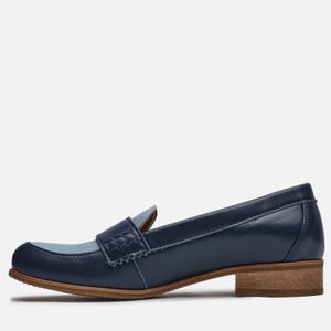 May include: Blue leather loafers with a light blue toe and a brown heel. The loafers have a simple design with a stitched detail on the toe.