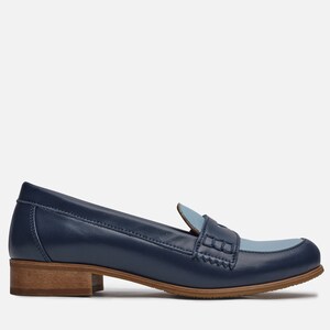 May include: A pair of blue leather loafers with a light blue leather accent on the toe. The loafers have a brown wooden heel.