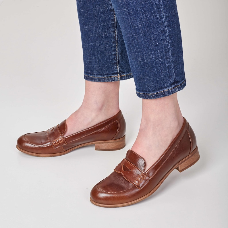 Brown shoes with round toes and sleek beige soles