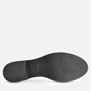 May include: Black shoe sole with a textured pattern and a smooth heel. The sole has the brand name "JULIUS" printed on it. The shoe sole is made of a durable material.