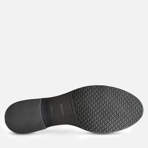 May include: Black shoe sole with a textured pattern and a smooth heel. The sole has the brand name "JULIANO" printed on it. The shoe sole is made of a durable material.