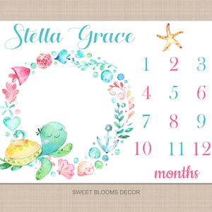 May include: A baby milestone growth chart with a watercolor design featuring a sea turtle, starfish, seashells, and a wreath of flowers. The chart has numbers 1 through 12 for each month and the text "Stella Grace" and "months".