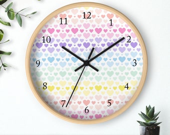 May include: A rainbow heart patterned clock with black hands and a wooden frame. The numbers 1 through 12 are printed on the clock face.