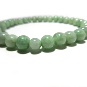 May include: A green jade bracelet with round beads.