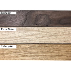 May include: Close-up of three wood samples: walnut, light oak, and oiled oak. The wood samples are arranged horizontally with the names of the wood types labeled above each sample.