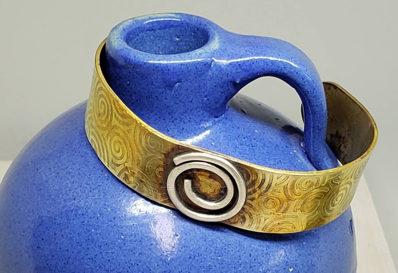 Celtic Inspired Hand Embossed Fire Treated Brass Cuff with Sterling Silver Spiral