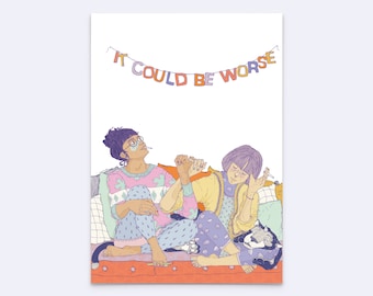 May include: A colorful illustration of two people sitting together on a couch, one with dark hair in a bun and the other with a bob haircut. Above them, a banner hangs with the text IT COULD BE WORSE. They are wearing patterned clothing.