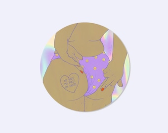 May include: A circular sticker featuring a tan-toned illustration of a lower torso wearing light purple underwear with a yellow smiley face pattern. A heart-shaped tattoo on the hip reads MY BODY MY RULES MY CHOICE. The background has a holographic effect.