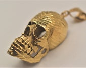 Large 10k, 30.9g, yellow gold 3D skull pendant.