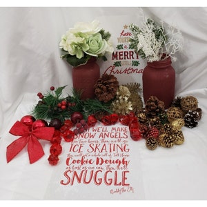 May include: A white canvas tote bag with red text that reads "We'll make snow angels for two hours, then we'll go ice skating, then we'll eat a whole roll of Toll House cookie dough as fast as we can, then we'll snuggle. Buddy the Elf."