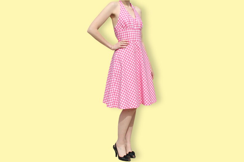 May include: A pink and white gingham halter dress with a fitted bodice and a full skirt.