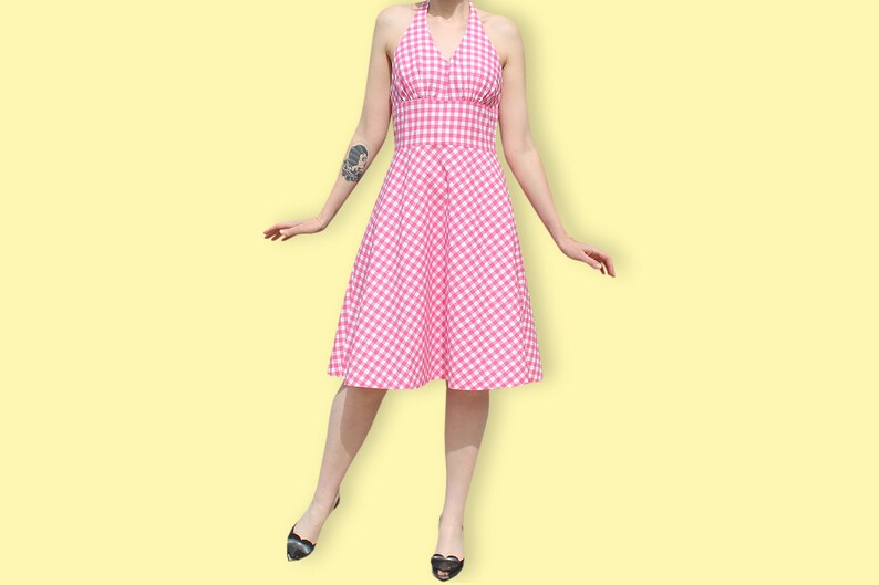 May include: A pink and white gingham halter dress with a fitted bodice and a full skirt.