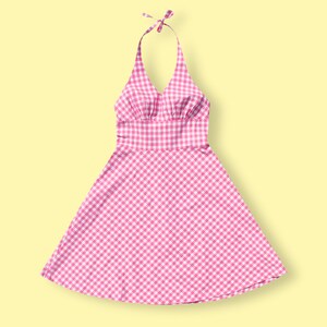 May include: A pink and white gingham halter dress with a fitted bodice and a full skirt.