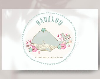 May include: A white circle with a blue border and the text "BABALOO handmade with love" inside. A blue whale with a small fish on its back is surrounded by pink and white flowers.