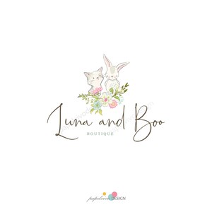 May include: A logo for a boutique called "Luna and Boo" featuring a white rabbit and a white cat with pink accents sitting on a bed of green leaves and pink, white, and blue flowers.