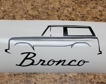May include: Black and white silhouette of a Ford Bronco with the word "Bronco" written underneath.