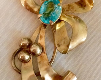 Vintage Carl Art gold bow brooch with large aqua crystal center stone
