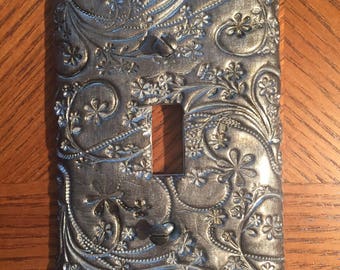 This elegant and beautiful switch plate has a flowery vine pattern in a gunmetal shimmer color Single toggle light switchplates large orders
