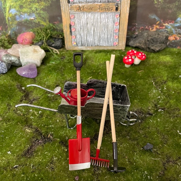 5 piece red fairy garden or dollhouse garden tool set. Included in this set are wheelbarrow/trolley, red watering can, spade, rake and hoe