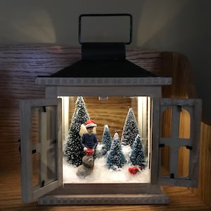 Sweet fairy boy with his dog out in the woods and winter snow scene in a french door lantern image 1