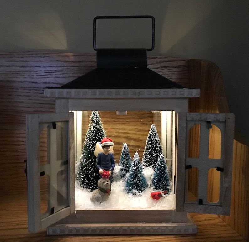 Sweet fairy boy with his dog out in the woods and winter snow scene in a french door lantern image 1