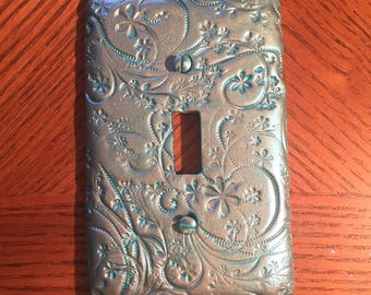 This elegant and beautiful switch plate has a flowery vine pattern in a teal silver shimmer color Single toggle light switchplate