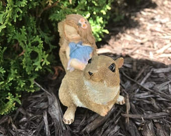 Little sleeping fairy on squirrel. Fairy garden supplies, outdoor garden accessories, fairy garden lawn display, miniature outdoor squirrel