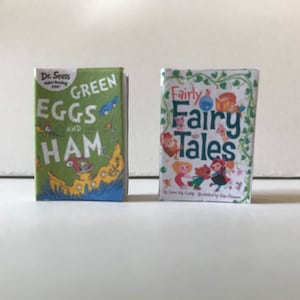 May include: Two children's books, one green with the title "Green Eggs and Ham" by Dr. Seuss, and the other white with the title "Fairly Fairy Tales" by Lora Bigler, illustrated by Dianna Chaney.
