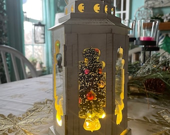 Pretty Christmas tree inside a white with gold accents lantern