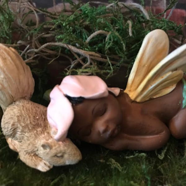 Precious baby fairy is sleeping peacefully while resting her sweet head on her precious squirrel friend.