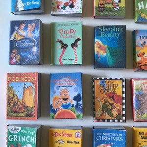May include: A collection of 16 miniature children's books, including classics like "The Cat in the Hat", "Fairy Tales", "Cinderella", "Sleeping Beauty", "The Real Mother Goose", and "How the Grinch Stole Christmas".