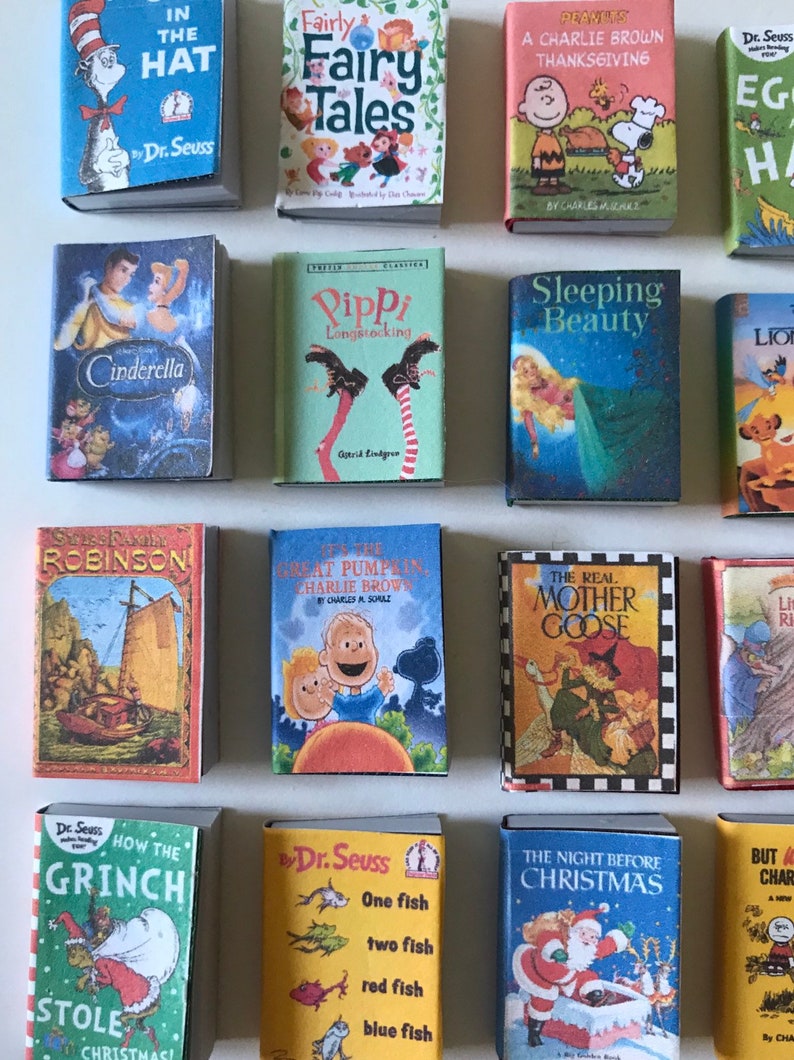 May include: A collection of 16 miniature children's books, including classics like "The Cat in the Hat", "Fairy Tales", "Cinderella", "Sleeping Beauty", "The Real Mother Goose", and "How the Grinch Stole Christmas".