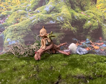 Pixie lovers garden pixie and baby green dragon perching on a log