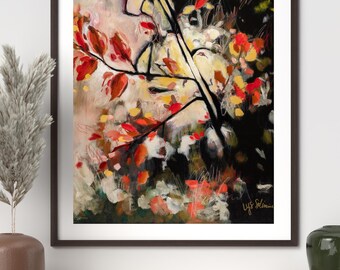 May include: Abstract art print showing a tree branch with red and orange leaves against a backdrop of white, yellow, and black. The artwork is framed in a dark brown frame and signed in the lower right corner.